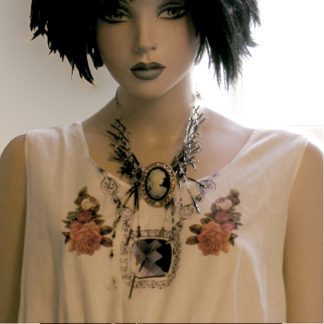 mannequin w short black hair and bluish makeup wearing bodice w printed rose stickers and printed gem necklace.